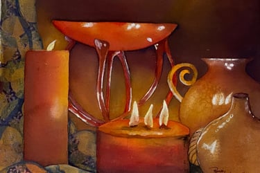 Candlelight casts golden reflections on glass vases lighting their curves and shadows in the drapery