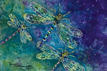 Three dragonflies dance their colors of teal, aqua, pink, purple and touches yellow in a night sky