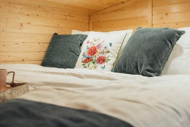 Tiny house double bed with green pillows