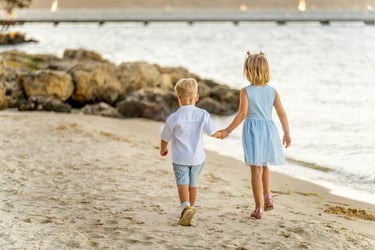 Brother and sister holding hands walking along Point Walter beach at sunset, Perth family photographer Fisher Photography