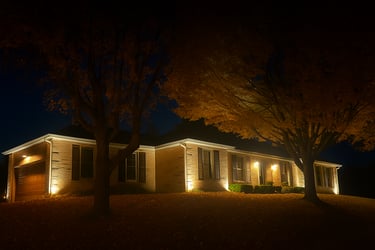 upward landscape lighting on a house at night in fall