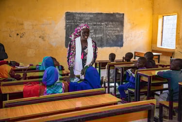 Rebecca in a classroom full of ABEP learners