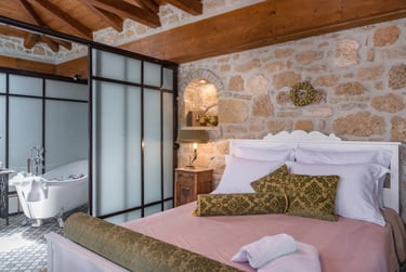 Convenient Queen size bed in open space bedroom with bathroom next to it in Villa Galanoussa Zakynthos