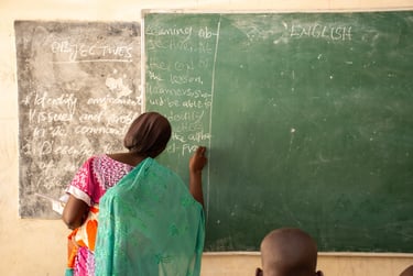 Rebecca standing in front of a chalkboard