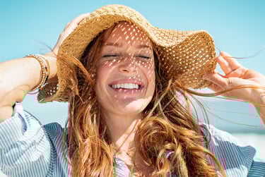 a woman with long hair and a hat on