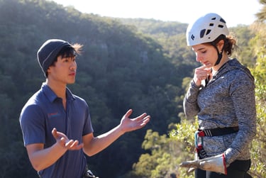 Participants learning rock climbing and abseiling skills in a hands on outdoor workshop.
