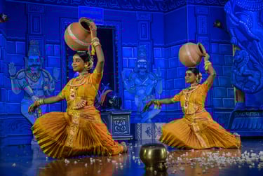 two women in traditional indian attire performing a dance