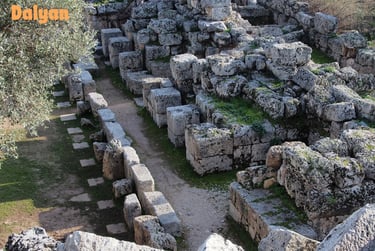 a stone wall with a path leading to a stone wall