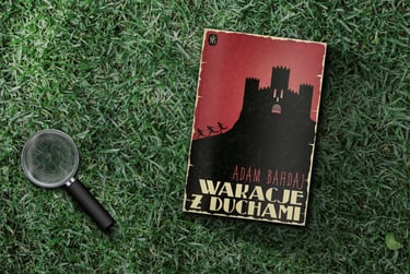 Book and magnifying glass laying on the grass