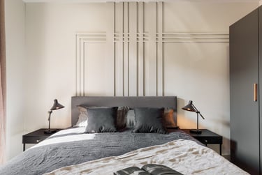Elegant bedroom with wall panels, calm color palette and modern minimalist design in Barcelona