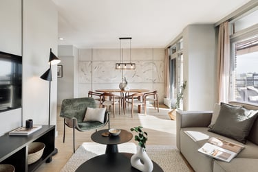 Elegant living room with contemporary furniture, custom art, and neutral tones designed by SAVIA