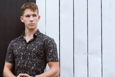 Portrait photo of a young man in an industrial black and white environment