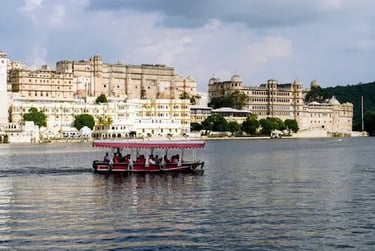 Boat ride on Lake Pichhola with City Palace Udaipur in the background.