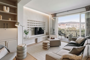 Elegant living room with bespoke wall installation, neutral tones, and subtle textures by SAVIA