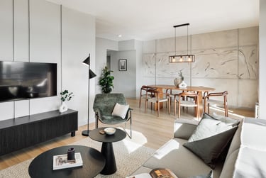 Modern dining area with metal light fixture, wooden dining table, and minimalist interior design
