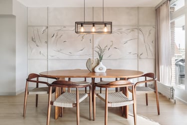 Modern dining area with metal light fixture, wooden dining table and minimalist design in Barcelona