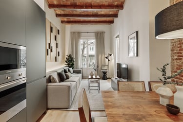 Living room with exposed brick ceiling, wood table and a mix of modern and rustic design
