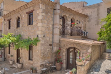 Close-up of the hand-carved natural stone walls of Villa Galanoussa, a historic survivor of the 1953 earthquake.
