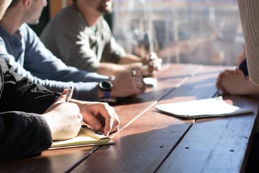A meeting showing a group of people sitting at a table