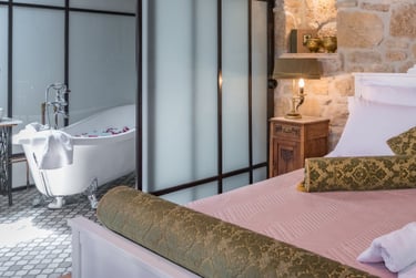 Convenient Queen size bed in open space bedroom with bathroom next to it in Villa Galanoussa Zakynthos