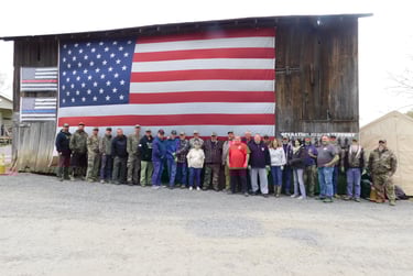 a group of people standing in front of a large american flag