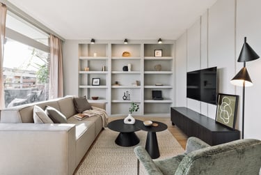 Elegant living room with contemporary furniture, neutral tones and custom bookshelf