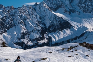two people skiing down a snowy mountain