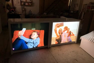 Backlit fabric light box displays featuring high-resolution lifestyle graphics in a warehouse setting.