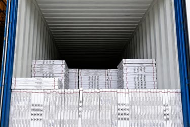 A blue shipping container loaded with stacked pallets of white packaged cargo for logistics and export.