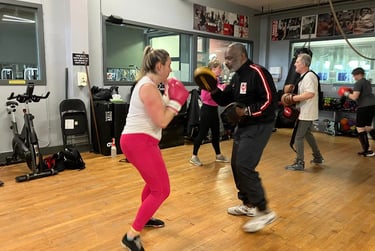 boxing instructor jon bottoms with boxing participant
