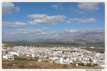 View of Arkalochori, Crete, with the town nestled against a backdrop of mountains.