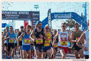 Runners participating in the Crete Half Marathon, moving with determination along the route