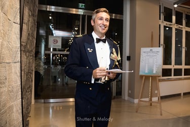 Ben Poxon ringing a bell for dinner in the foyer of the Australian Embassy.