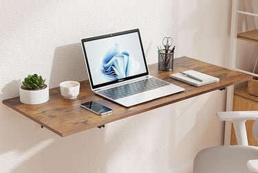 Wall-mounted folding desk with laptop and succulent in a small apartment home office — space-saving 