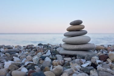 Peaceful image of stacked smooth rocks on a beach