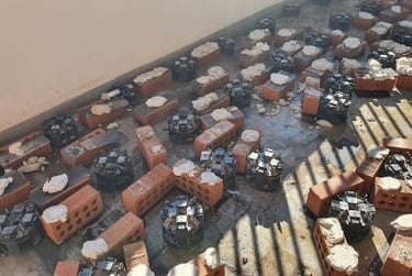 Using bricks under pedestal tiles to try and 