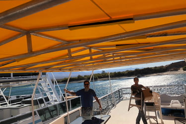 Replacing Houseboat Party Top cover made with Sunbrella Marine Fabric.