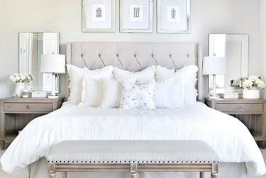 a bedroom with a bed and a bench with a bench and a bench with a