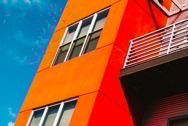 a red building with a balcony and a balcony