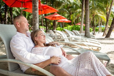Couple relaxing together beneath palms near Khem Beach