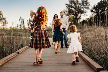 a family walking across a bridge with their children