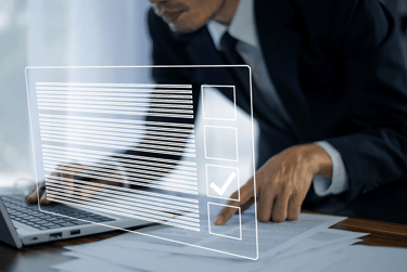 a man in a suit and tie is holding a laptop
