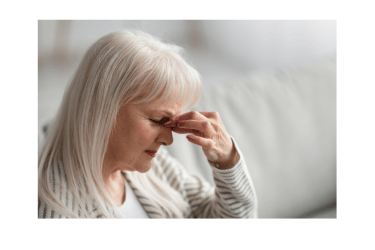 Woman with eyes closed, pinching bridge of nose
