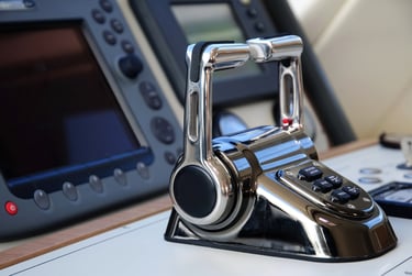 Dual boat throttles with marine electronics in the background.