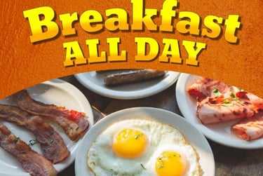 Breakfast all day menu with sunny side up eggs, crispy bacon, sausage, and ham on white plates.