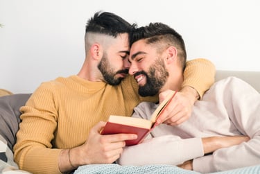 a gay sugar daddy with his sugar boy sitting on a couch