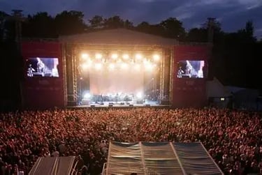 a views of the stage at the open air theatre at Scarborough. There is a show on. Bright stage lights