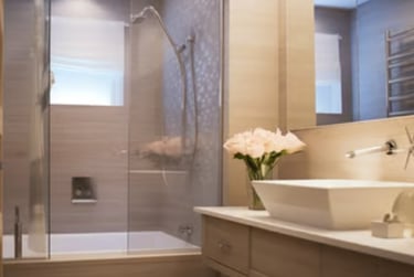 Modern bathroom interior featuring a glass walk-in shower, soaking tub, and vanity with a vessel sink.