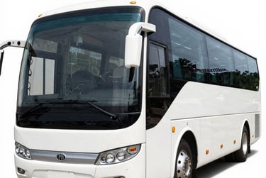 A large white luxury charter bus with tinted windows isolated on a white background.