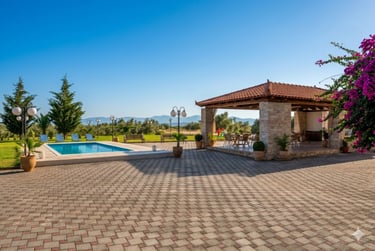 Tradition villa backyard with a blue swimming pool, stone patio, and covered outdoor dining pavilion